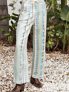 Step into summer style with these unique multicolor embroidered pants. Made in India, each pair features a trendy design and wooden button, adding a touch of quirkiness to your wardrobe. Stay cool and fashionable all season long! Color: Summer Fabric: 100% Cotton Includes: x1 Pants Sizes: XS-XL, Regular Sizing. Model is 5'8" and is wearing a size S. Chic Pants For Spring Festival, Trendy Straight Leg Beach Bottoms, Casual Long Pants For Festival, Spring Hippie Loungewear Pants, Hippie Summer Trousers, Hippie Style Spring Loungewear Pants, Trendy Straight Leg Vacation Bottoms, Trendy Straight Leg Bottoms For Vacation, Trendy Straight Leg Beach Pants