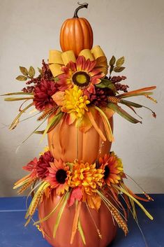 a large pumpkin decorated with flowers and leaves