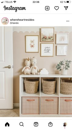 a white shelf with baskets and pictures on it