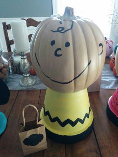 a pumpkin sitting on top of a wooden table