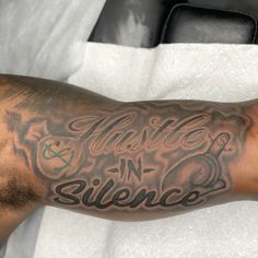 a man with a tattoo on his arm that says, hustle n'silence