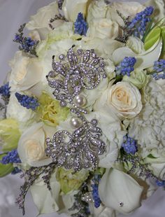 a bridal bouquet with brooches and flowers