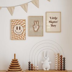 a wooden shelf topped with toys next to pictures and posters on the wall above it