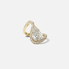 a pear shaped diamond ring set in yellow gold