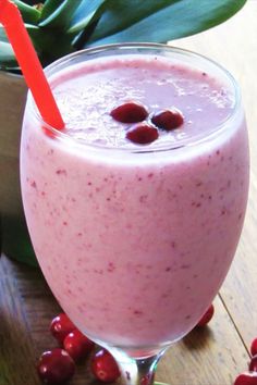 a smoothie with cranberries on the table