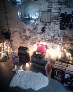 a room with disco balls, lights and various items on the floor in front of it