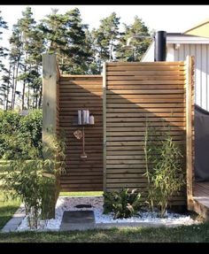 an outdoor shower in the middle of a yard