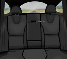 the interior of a car with black leather seats and grey dash mats, looking out over an open field