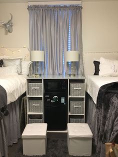 a bedroom with two beds and a night stand