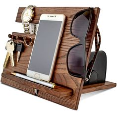 a cell phone, sunglasses and keys in a wooden holder