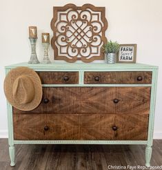 an old dresser has been painted green and is decorated with wood accents, such as a stencil