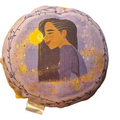 a round pillow with an image of a woman kissing a flower