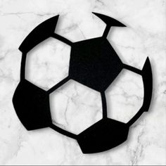 a black and white photo of a soccer ball on a marble surface with the word,'football'written below it