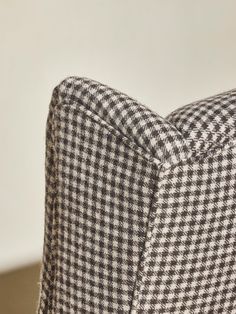 a close up view of the back end of a chair with houndskin pattern on it