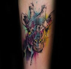 a colorful giraffe tattoo on the right arm and leg with watercolor splashs