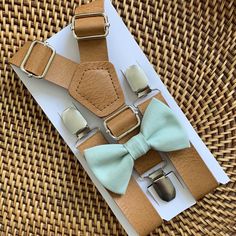 "Your special guy will look so dashing when he shows up wearing this sage green bow tie and faux leather suspenders set! This bow tie is a great choice for family photos, wedding, ring bearer outfit, page boy outfit, birthday celebration or any other special occasion. ❤ **Please Specify** SET- Bow Tie and Suspenders SUSPENDERS- One Pair of our Quality Suspenders BOW TIE - One Bow Tie on White Adjustable STRAP or Alligator CLIP **PLEASE NOTE: CLIP ON Bow Ties are Recommended/Suitable for Children Sage Bow Tie, Sage Green Bow Tie, Leather Suspenders Wedding, Wedding Suspenders, Groomsmen Suspenders, Baby Suspenders, Suspenders For Boys, Suspenders Wedding, Gentlemen Wear