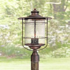 Add a warm glow to your walkway, driveway, or front yard with this outdoor post light from the Casa Mirada collection. It comes in a traditional lantern style for a timeless look that fits into any setting. The bronze finish frame holds a seeded glass cylinder shade in the middle, forming a design that offers a charming vintage vibe. Size: 20 x 13 x 13.  Color: Brown. Mermaid Bath, Industrial Outdoor, Deck House, Outdoor Lighting Design, House Porch, Driveway Lighting, Outdoor Post Light, Traditional Lanterns, Cottage Style Homes