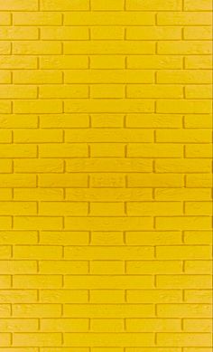 a yellow brick wall that is very close to the ground