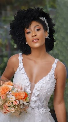 a woman in a wedding dress holding a bridal bouquet and looking at the camera