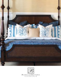 a bed with blue and white pillows on it