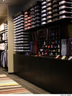 there are many hats and ties on display in the store's men's clothing section