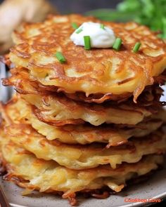 stack of potato pancakes with sour cream on top