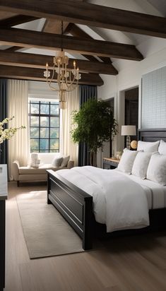 a bedroom with a large bed, chandelier and two couches in it