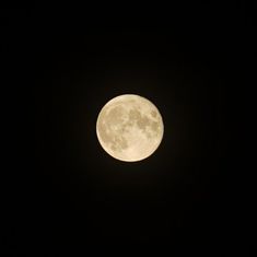 the full moon is seen in the dark sky with no clouds on it's side