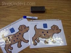 two stickers with dogs on them are sitting next to a pen and paper bag