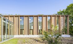 an exterior view of a house with wood sidings and glass doors on the outside