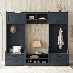 a room with some black cabinets and white rugs on the floor in front of it