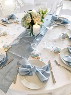 the table is set with silverware and blue napkins