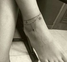 a woman's foot with a star tattoo on it