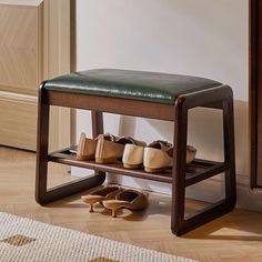 a wooden shoe rack with several pairs of shoes on it next to a rug and door