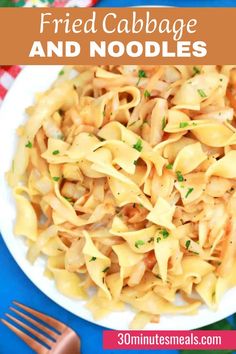 a white plate topped with pasta and sauce next to a fork on a blue table cloth