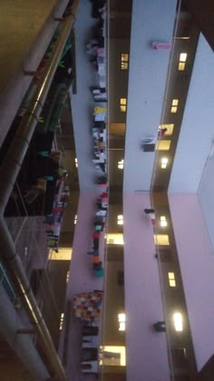 an overhead view of people standing in the middle of a building with their lights on