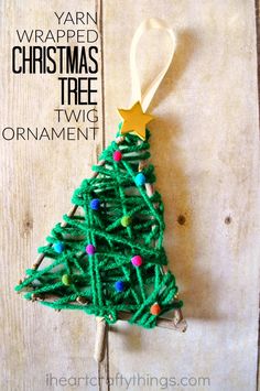 a yarn wrapped christmas tree ornament hanging on a wall