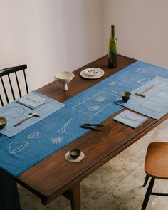 the table is set with place settings for two people to sit at, and there are plates on it