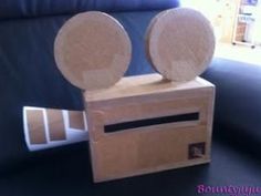 a wooden box with two speakers on it sitting on a table next to a couch