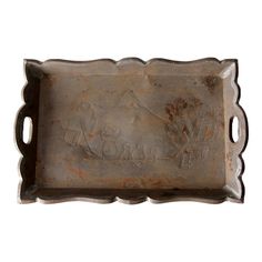 an old metal tray with some writing on the front and side, sitting against a white background