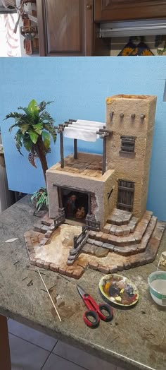 a small oven sitting on top of a counter next to some scissors and other items