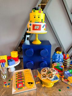 a table topped with lego toys and cake