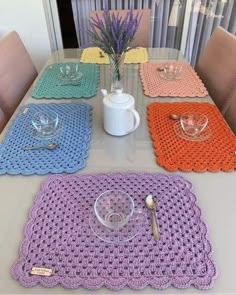 crocheted placemats and dishes on a table