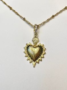 A beautiful 14k gold sacred heart necklace on a 14k gold filled satellite chain. Choose a custom length. All Lengths come with 2 inch extender chain. Featuring cubic zirconia pave detailing on the bail.Looks great both by itself and/or layered with other necklaces. Spooky Accessories, Milagro Heart, Sacred Heart Necklace, Gold Heart Pendant, Slouch Socks, Catholic Jewelry, Rose Pendant