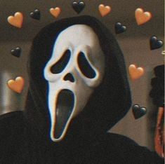 a person wearing a white mask with hearts around them