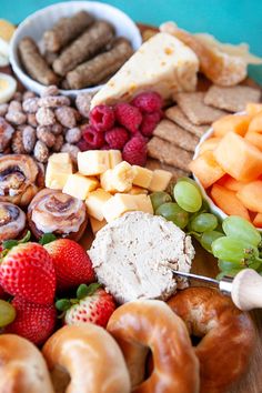 a close up of a plate of food with fruit and crackers on the side