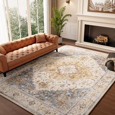 a living room with a couch, rug and fireplace