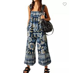 Update Your Closet With A Stylish Boost With The Bali Albright Jumpsuit From Free People. Punctuated By An Eye-Catching Print And Classic Square Neckline, This Chic Pick Is Ideal For Pairing With Your Favorite Wedges For A Well-Rounded Look. Size Large Color Navy Combo Floral Print Square Neckline Sleeveless Ruffle Straps Balloon Leg Cuffed Hem Smocked Back Tie Back Closure Approx. 25.75" Inseam; 19" Rise; 40" Bust; 42" Waist Cotton Machine Wash/Line Dry Jumper Is Brand New And Has Never Been Wo Blue Wide Leg Summer Overalls, Bohemian Blue Overalls For Summer, Chic Blue Wide Leg Overalls, Blue Summer Overalls, Free People Jumpsuit, Free People Romper, Boho Jumpsuit, Tie Waist Jumpsuit, Leg Cuffs