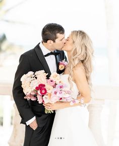 a bride and groom kissing each other on their wedding day