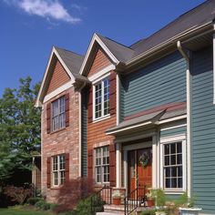 a row of houses with red and blue siding